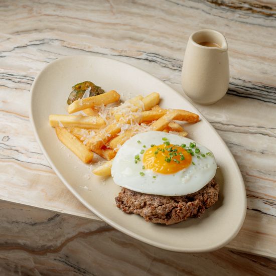 Chopped beef steak, french fries, marinated cucumber